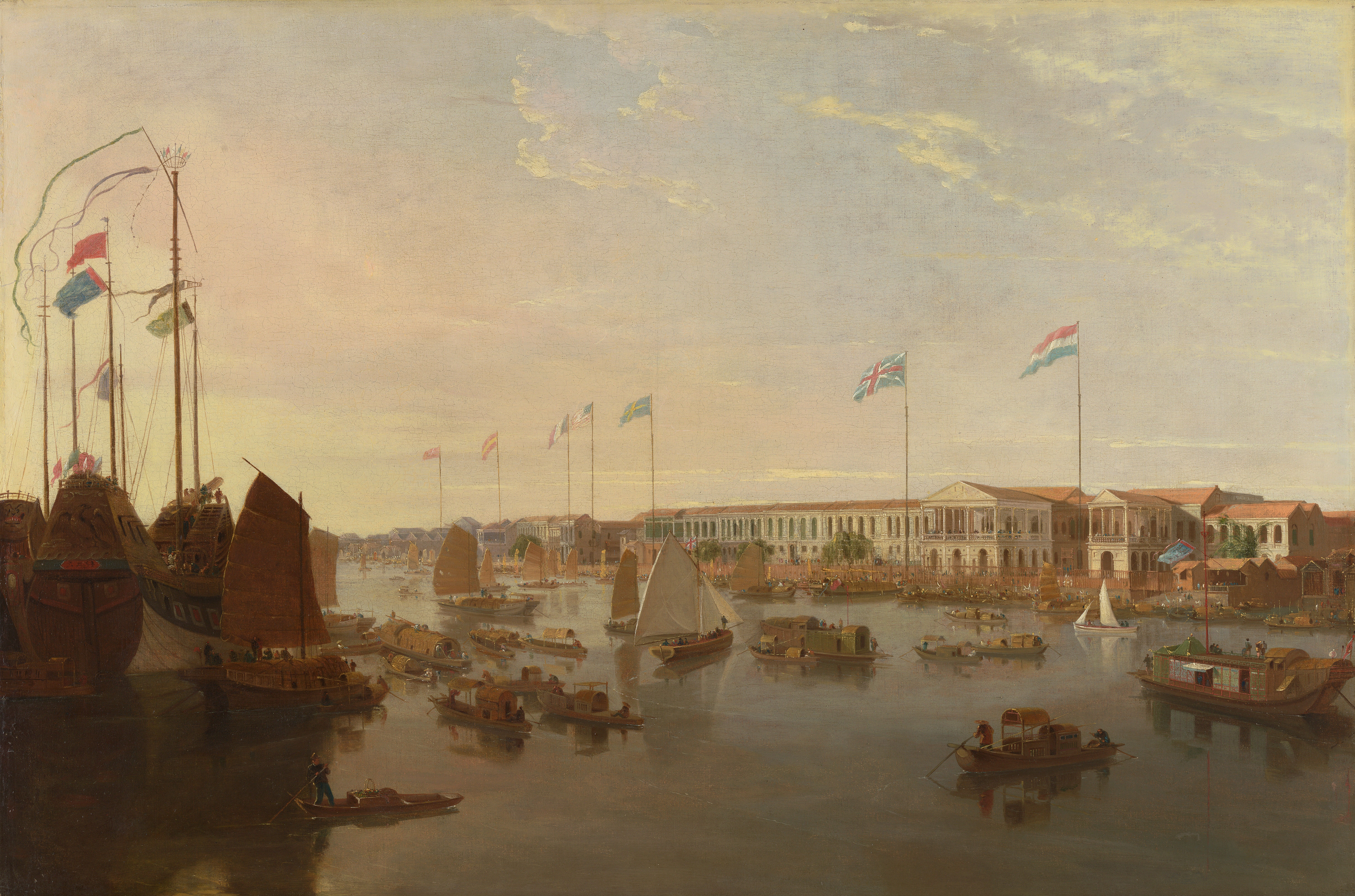 A harbour scene with multiple types of ships and nationalities of flags being flown